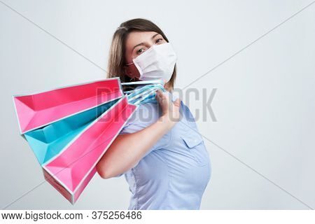 Attractive woman wearing protective mask isolated over white background