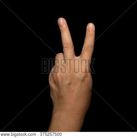 The Man's Hand That Holds Two Fingers Is A V Sign, Meaning Victory. Or Still Means Peace And Contemp