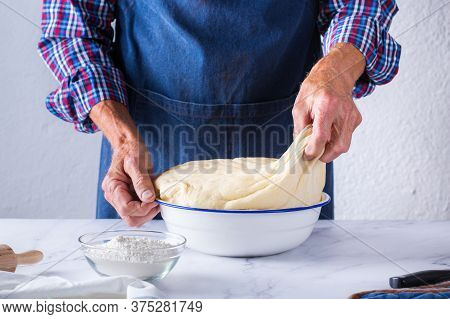 Baking At Home Concept. Senior Man Hands Cooking, Making Dough