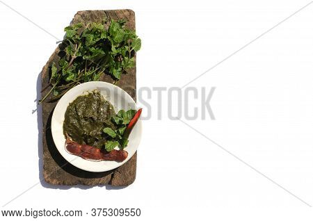 Pudina Chutney Or Field Mint Leaves Paste In A Plate With Raw Ingredients On Wooden Piece Isolated O