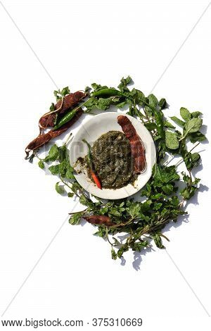 Pudina Chutney Or Field Mint Leaves Paste In A Plate With Raw Ingredients Isolated On White Backgrou