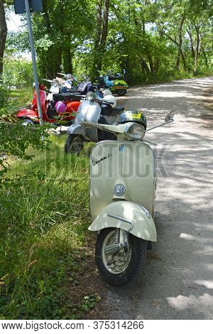 Villaggio Di Punta Sdobba, Italy - June 14 2020. Seven Vespas, Part Of A Small Rally Of Vespa Motori