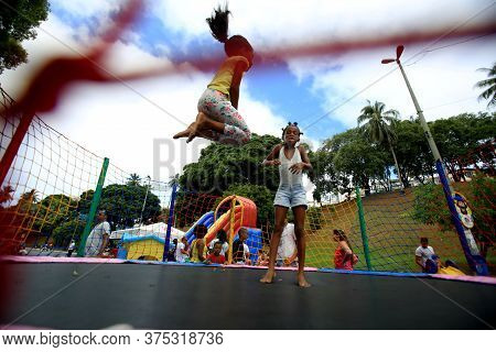 Salvador, Bahia / Brazil - February 21, 2016: Children Are Seen Playing On The Pogo Stick In The Dik