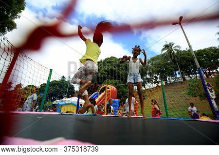 Salvador, Bahia / Brazil - February 21, 2016: Children Are Seen Playing On The Pogo Stick In The Dik