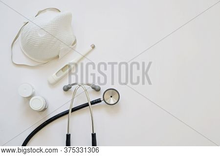 Flar Lay With Medical Instruments Stethoscope, Thermometer And Protective Mask On White Background. 