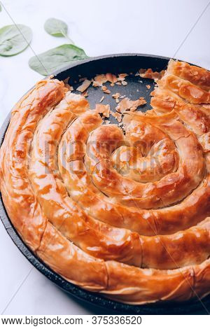 Filo Spinach And Feta Twist Pie In The Iron Pan After Oven. Authentic Greek Bakery. With Spinach, Mi