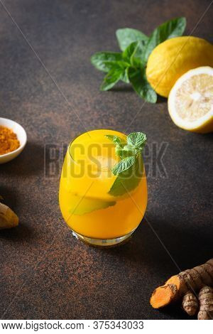 Jamu Indonesian Beverage With Turmeric, Ginger, Ingredients On Dark Background. Vertical. Close Up.