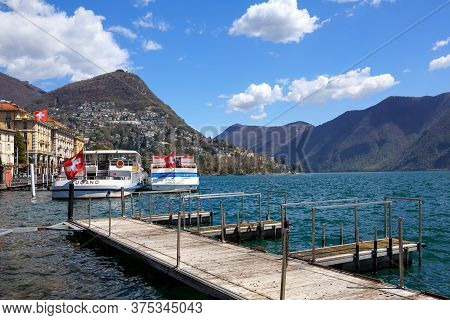 Lugano, Switzerland - April 17, 2018. City Of Lugano At The Lake Lugano, Surrounded By Alps. View Of