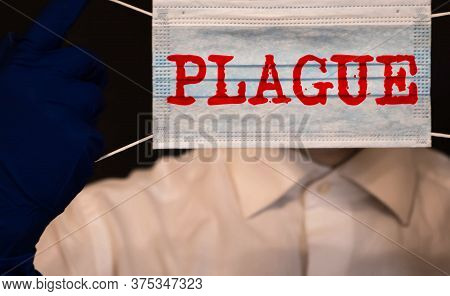 Wooden Cubes With Word Plague In An Old Brown Box