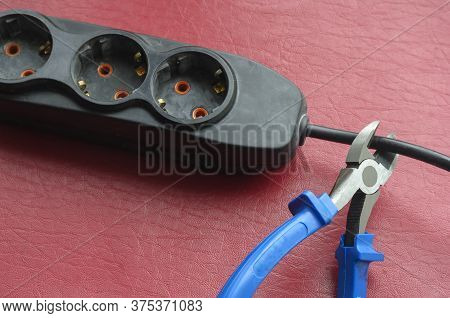 Nippers With Blue Handles Cut The Cable Splitter Cable. Emergency Disconnection Of The Consumer From