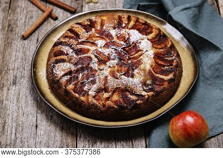 Eplekake. Traditional Norwegian Apple Cake Or Pie Sprinkled Sugar And Cinnamon On Old Rustic Wooden 