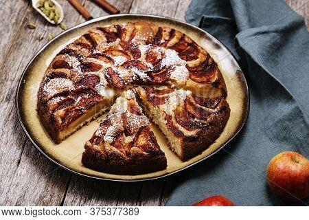 Eplekake. Traditional Norwegian Apple Cake Or Pie Sprinkled Sugar And Cinnamon On Old Rustic Wooden 