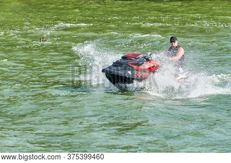 Voronezh, Russia - 23.08.2019 - Man On Water Scooter. Splashes And Drops Around. Summer Vacation On 