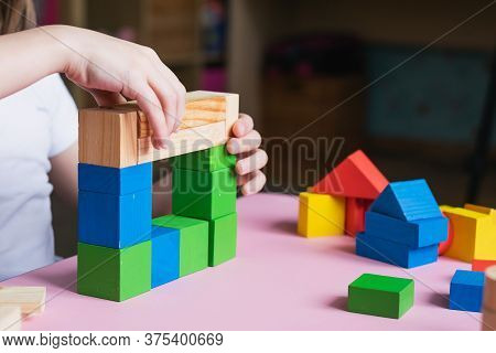 Little Kid Plays Assemble With Wooden Cubes Constructor. Education Concept For Children Learning. Ch
