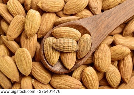 Almonds, Almonds On Wooden Spoon Over Almonds Background, Top View