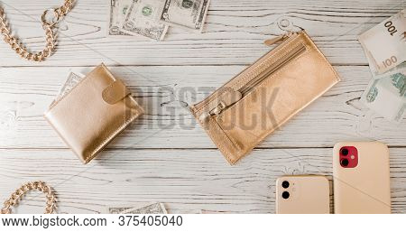Two Gold Wallets, A Gold Chain, Dollars, Rubles, An Two Expensive Smartphones With Two Cameras On A 