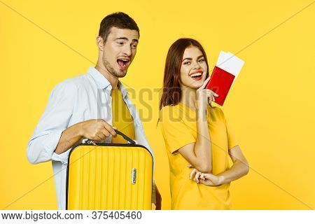 Loving Couple Go On A Trip And A Yellow Uitcase Passport Tickets