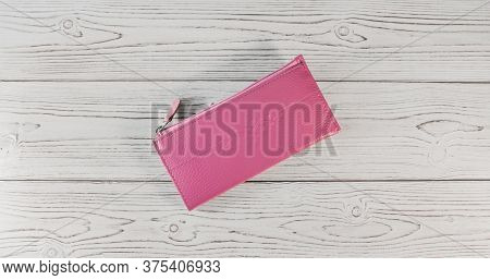 Pink Wallet On A Wooden Board Background. Top View. Flatlay