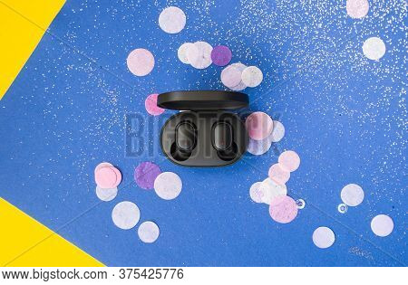 Ear Buds On Bright Yellow And Classic Blue Background With Colorful Confetti And Sparklets. Festive 