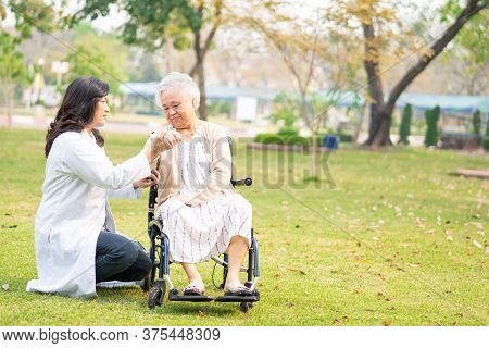 Doctor Help And Care Asian Senior Or Elderly Old Lady Woman Patient Sitting On Wheelchair At Park In