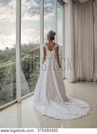Beautiful Bride In Her Wedding Dress Posing For Photos.