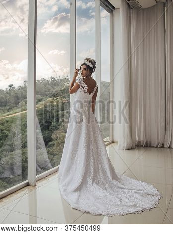 Beautiful Bride In Her Wedding Dress Posing For Photos.