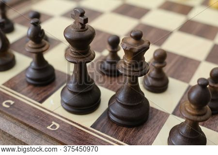 Chess Pieces On The Board. Wooden Chess Pieces On The Chessboard.