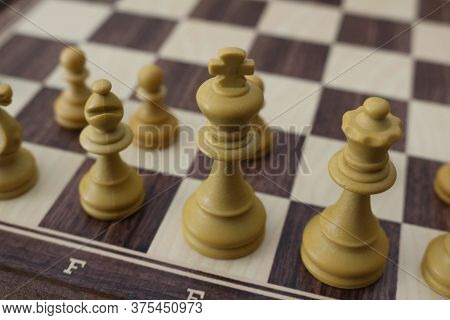 Chess Pieces On The Board. Wooden Chess Pieces On The Chessboard.