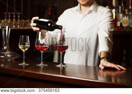 Sommelier Pouring Different Types Of Fine Wine