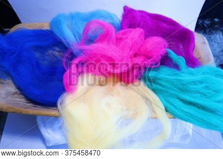 Lot Of Colorful Genuine Wool On A Woodenboard