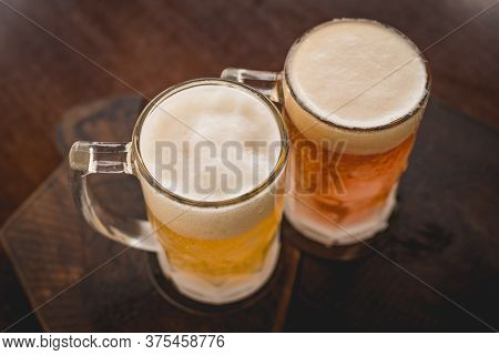 Two Mugs Of Chopp On The Table