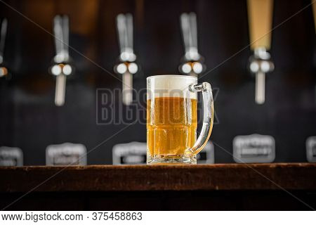 Mug Full Of Chopp, With Chopp Pilsen On A Rustic Table