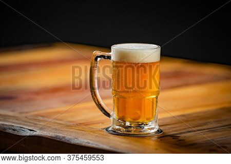 Mug Full Of Chopp, With Chopp Pilsen On A Rustic Table