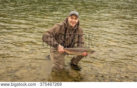 Kitimat, British Columbia, Canada - July 27th, 2015:a Fisherman Holding Up A Doe Sockeye Salmon At S