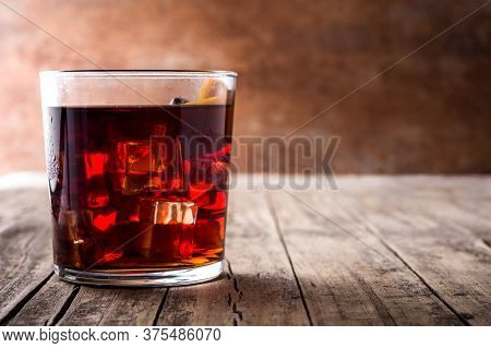 Boulevardier Cocktail And Orange Zest In Glass. Copy Space