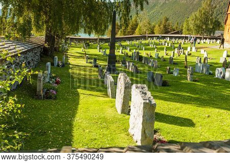Lom, Norway - July 7, 2018: Graveyard With Old Tombstones Around Lom Stave Church In Oppland County,