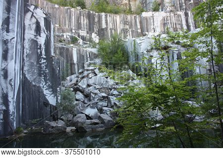 Small Natural Lake Inside A Marble Quarry In Mountain In Apuan Alps
