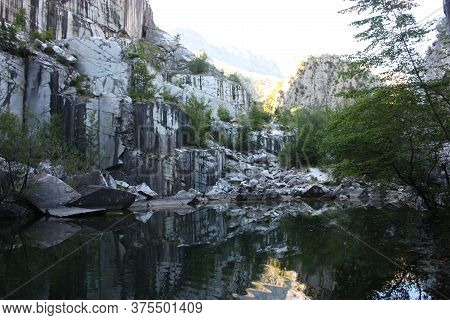 Small Natural Lake Inside A Marble Quarry In Mountain In Apuan Alps