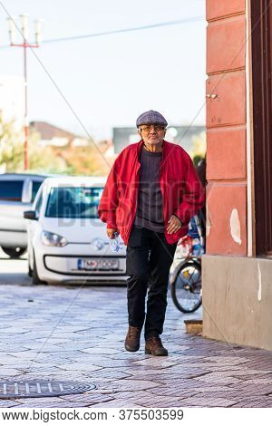 Old Man Walking Alone In Downtown Of Lugoj, Romania, 2020