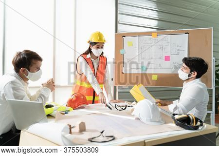 Scene Of Construction Engineers Discussing While All Of Them Wearing A Surgical Mask To Protect Coro