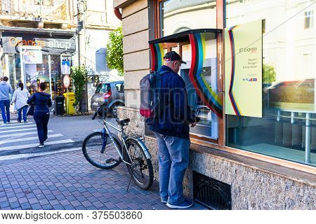 Man Using An Atm In Downtown Of Lugoj, Romania, 2020
