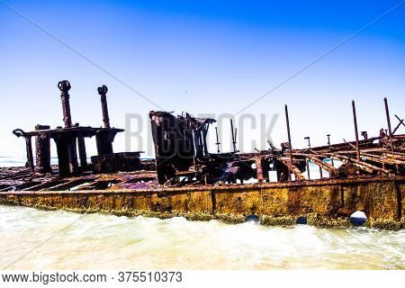 Photograph Of The Shipwreck Of The Ss Maheno On Fraser Island With A Cloudless Sky In The Background