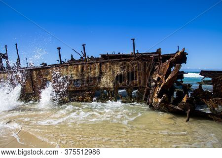 Photograph Of The Shipwreck Of The Ss Maheno On Fraser Island With A Cloudless Sky In The Background