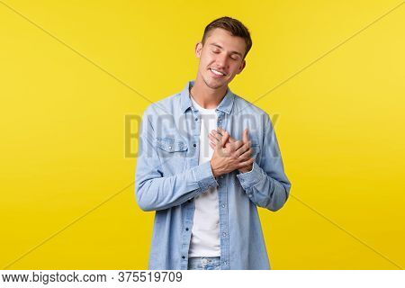 Happy Smiling Handsome Man Close Eyes And Smiling While Holding Hands On Heart, Keep Dearest Preciou