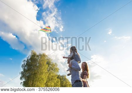 The Family Launches Kite Against Beautiful Sky