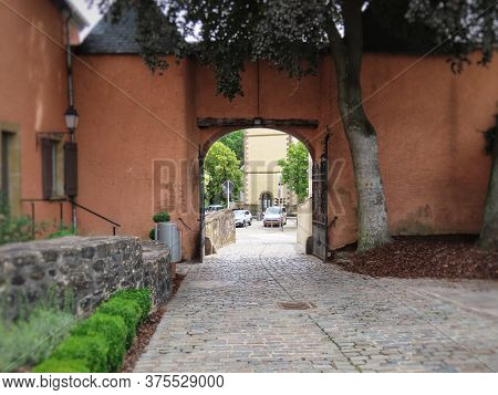 Mersch Castle Gate In Luxembourg, Today Used As City Hall. Seen From Inside On Sunny Summer Day
