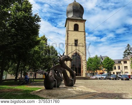 Dragon Of Mersch. Bronze Sculpture And Fountain By P.eyschen. Mersch And St. Michaels Or Old Tower, 