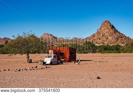 Twyfelfontein, Namibia - Jul 10, 2019: Wrecked Cars Lie Abandoned In The Desert Surrounding Twyfelfo