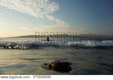 Banyuwangi, Indonesia - July 04, 2020 : A Woman Playing With The Dogs At Watudodol Beach Banyuwangi 