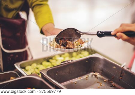 Starving Homeless People Receive Food From Volunteers Who Serve Humane : The Concept Of Giving